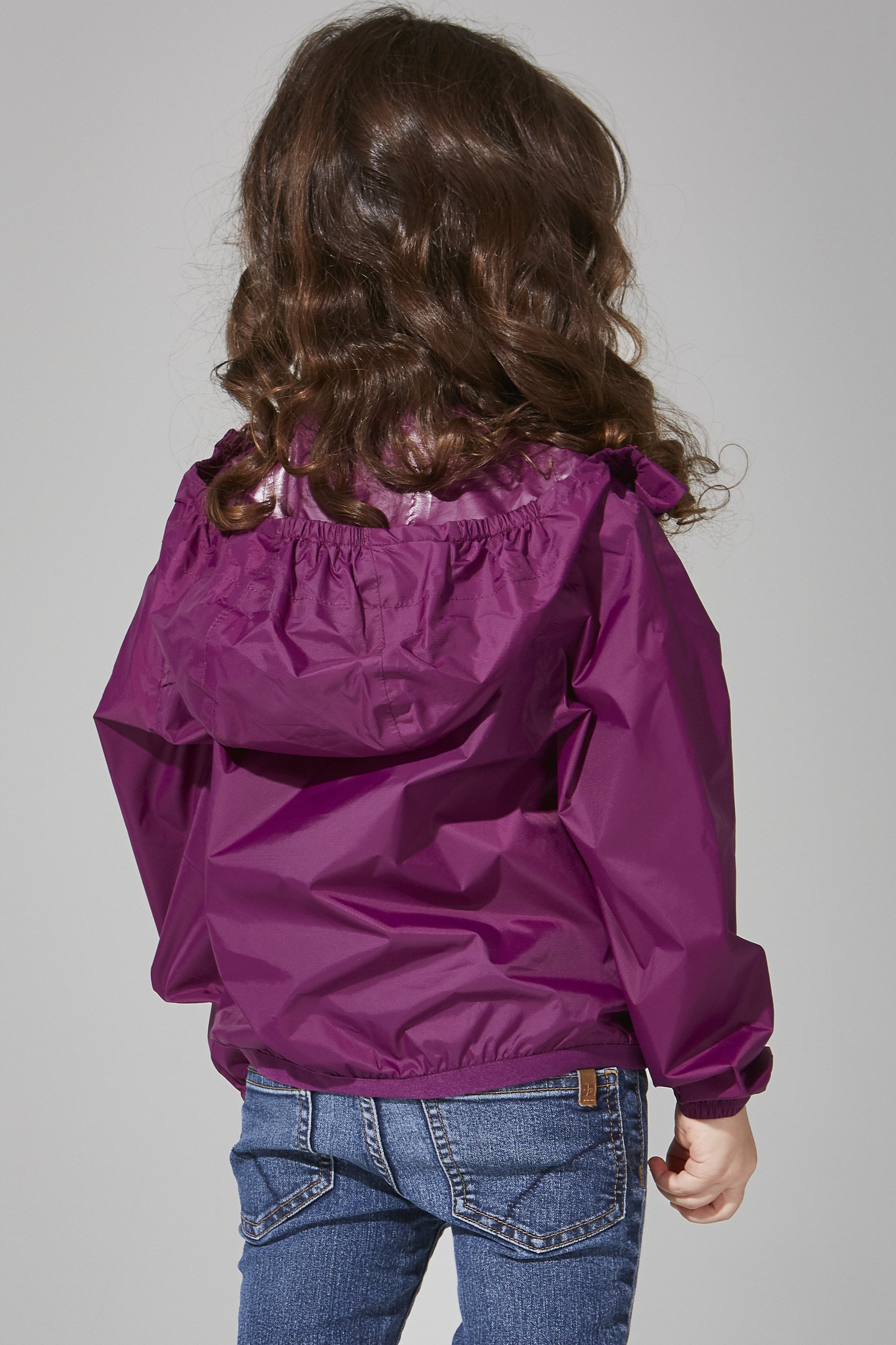 Kids Grape Full Zip Packable Rain Jacket displayed on a hanger, showcasing its vibrant color and full-zip design.