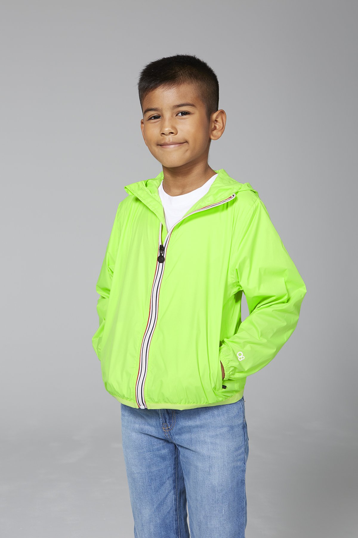 Kids green fluo full zip packable rain jacket, showcasing its vibrant color and packable design.