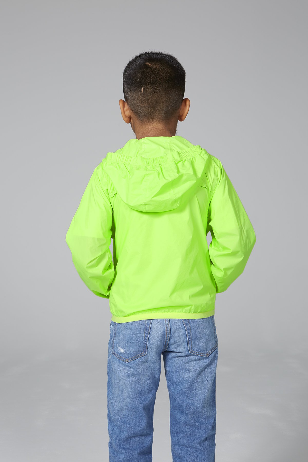 Kids green fluo full zip packable rain jacket, showcasing its vibrant color and packable design.