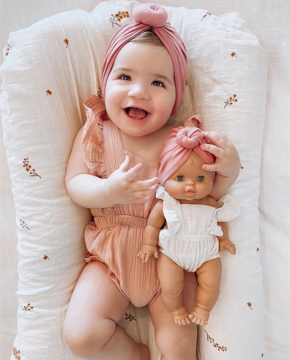 A stylish linen ruffle romper in plum color with ruffled straps and leg openings, featuring a tie closure at the back.