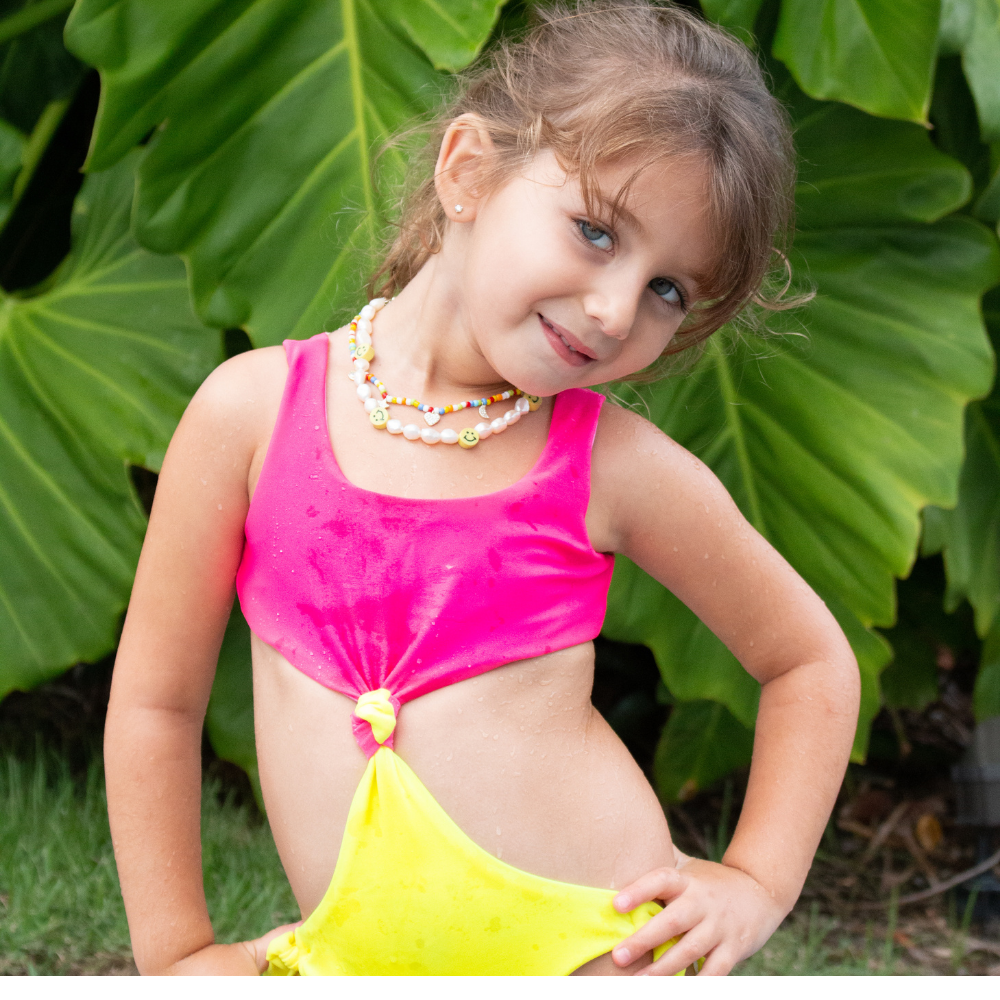 Colorful Neon Trikini for kids, featuring vibrant patterns and UV protection, perfect for summer swimming.