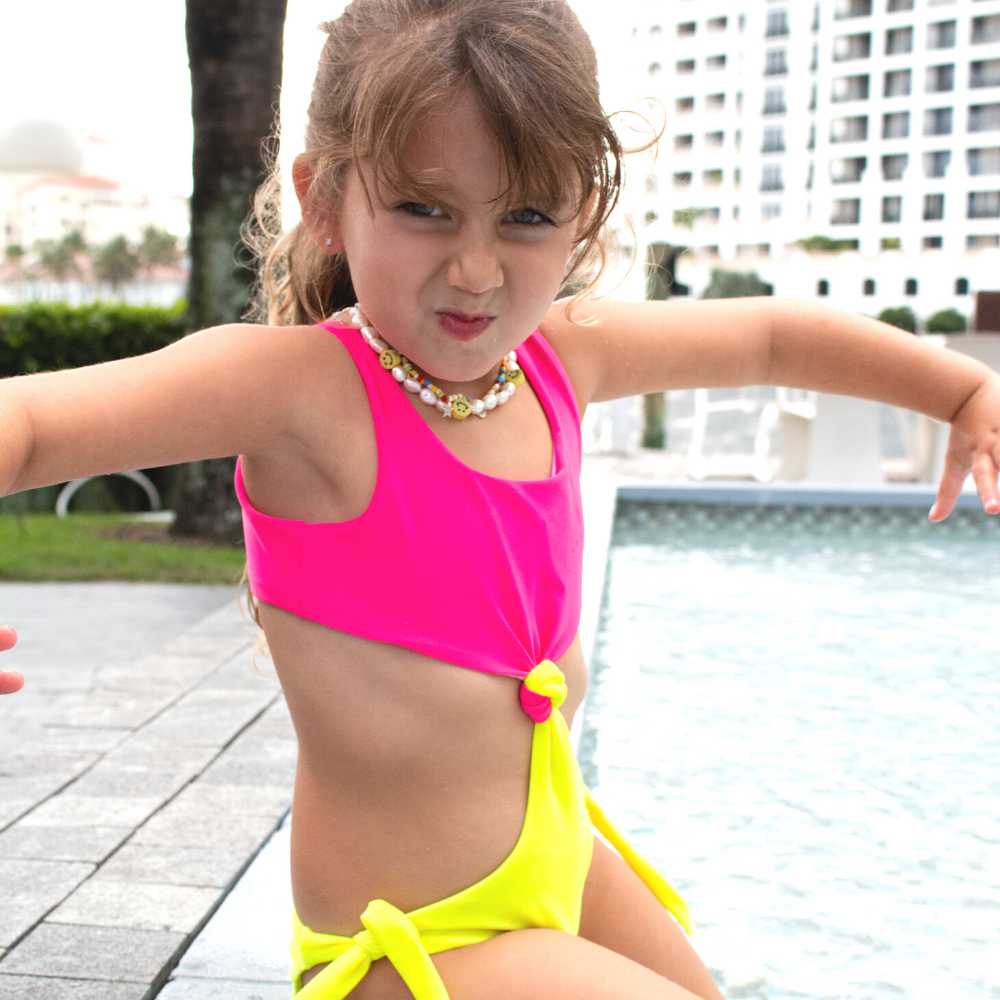 Colorful Neon Trikini for kids, featuring vibrant patterns and UV protection, perfect for summer swimming.