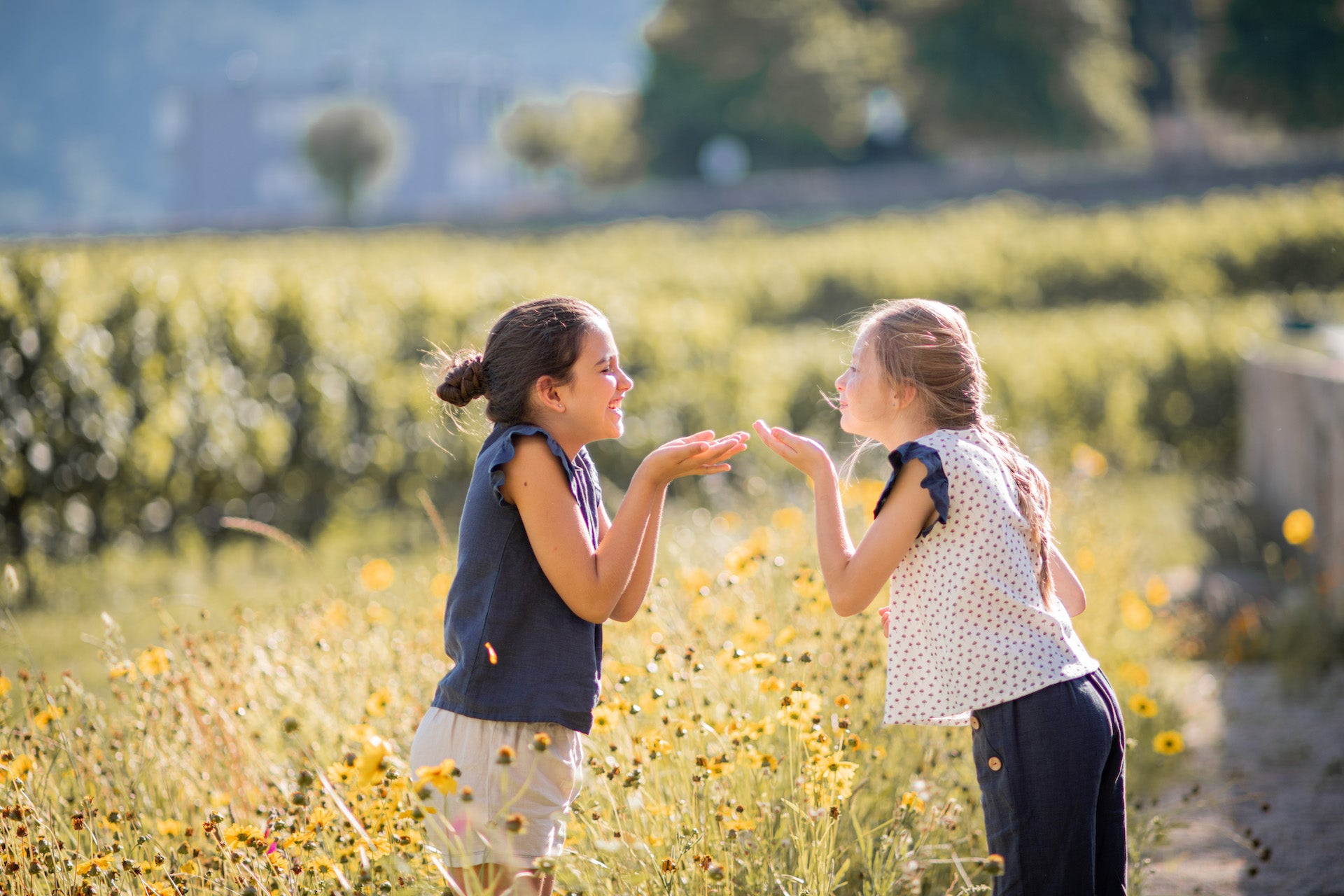 Two children playing in field.