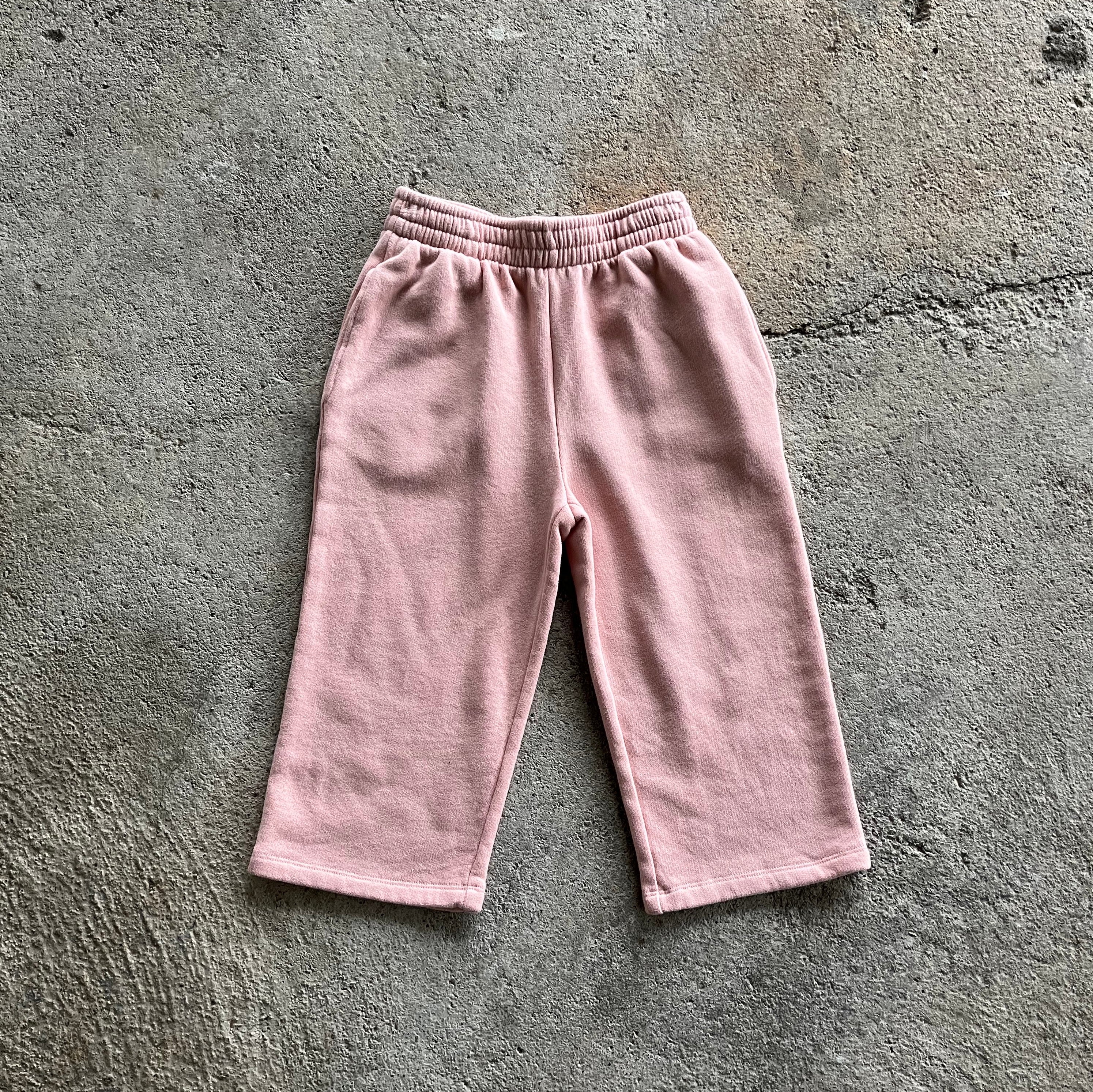 Warm and casual pink pants for kids with elasticised waist and side pockets, made from soft brushed cotton fleece.