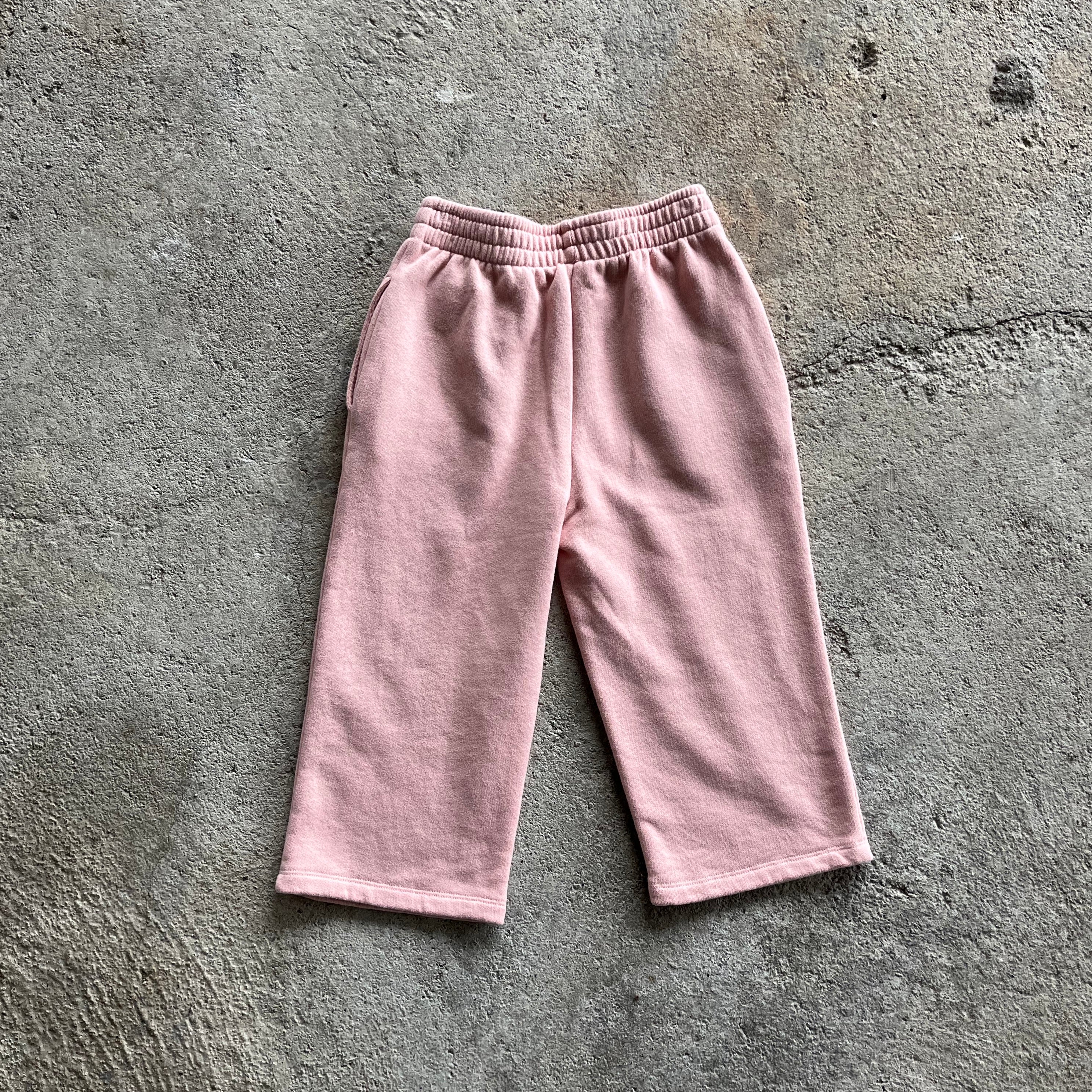 Warm and casual pink pants for kids with elasticised waist and side pockets, made from soft brushed cotton fleece.