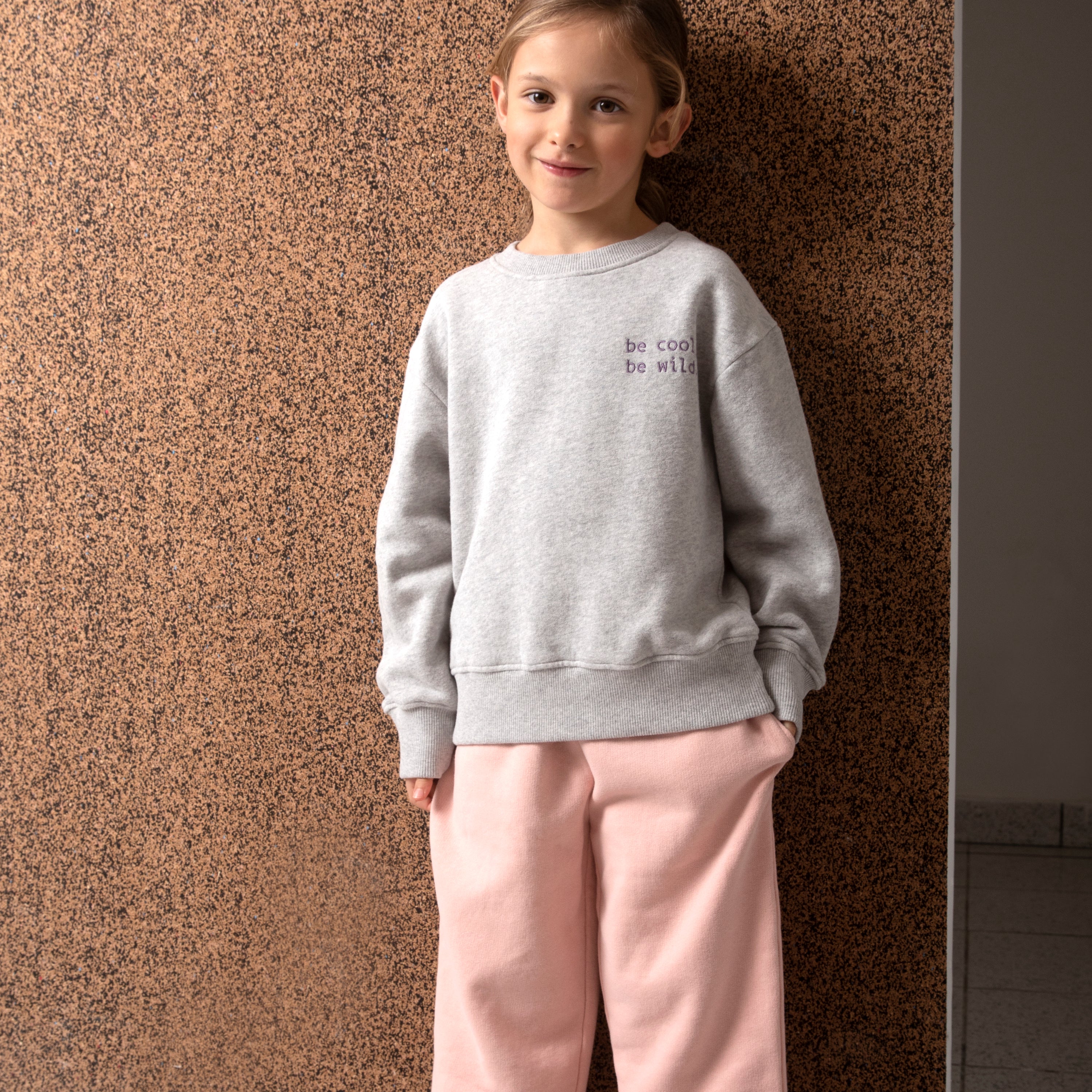 Warm and casual pink pants for kids with elasticised waist and side pockets, made from soft brushed cotton fleece.