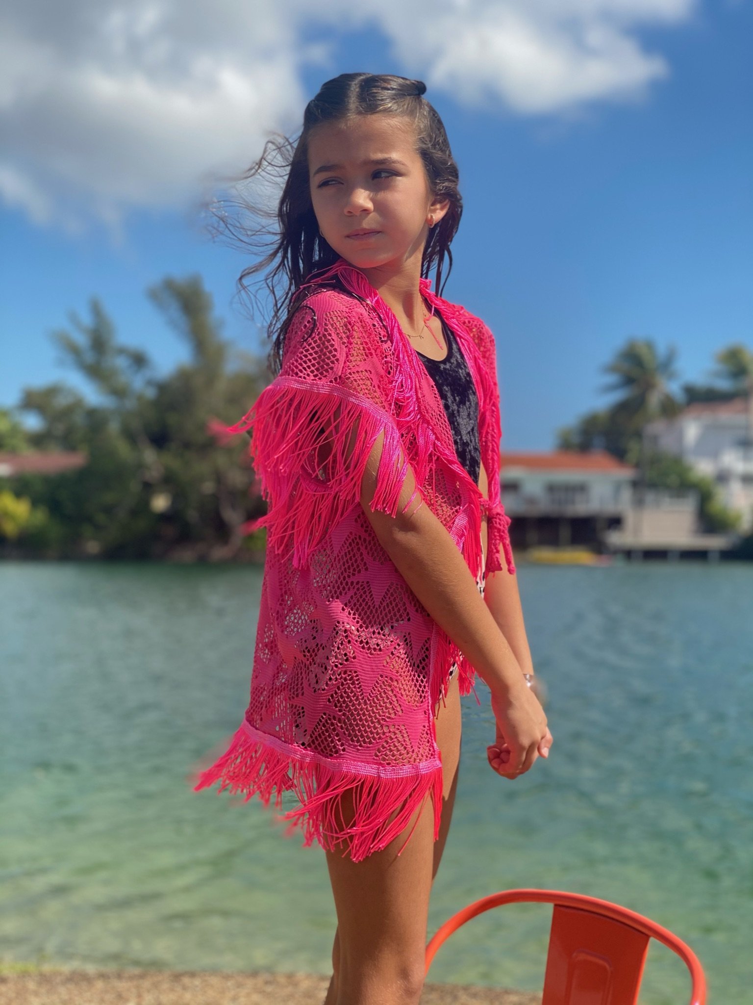 A stylish pink mesh cover up with star patterns, perfect for beach and poolside wear, showcasing its lightweight and breathable fabric.