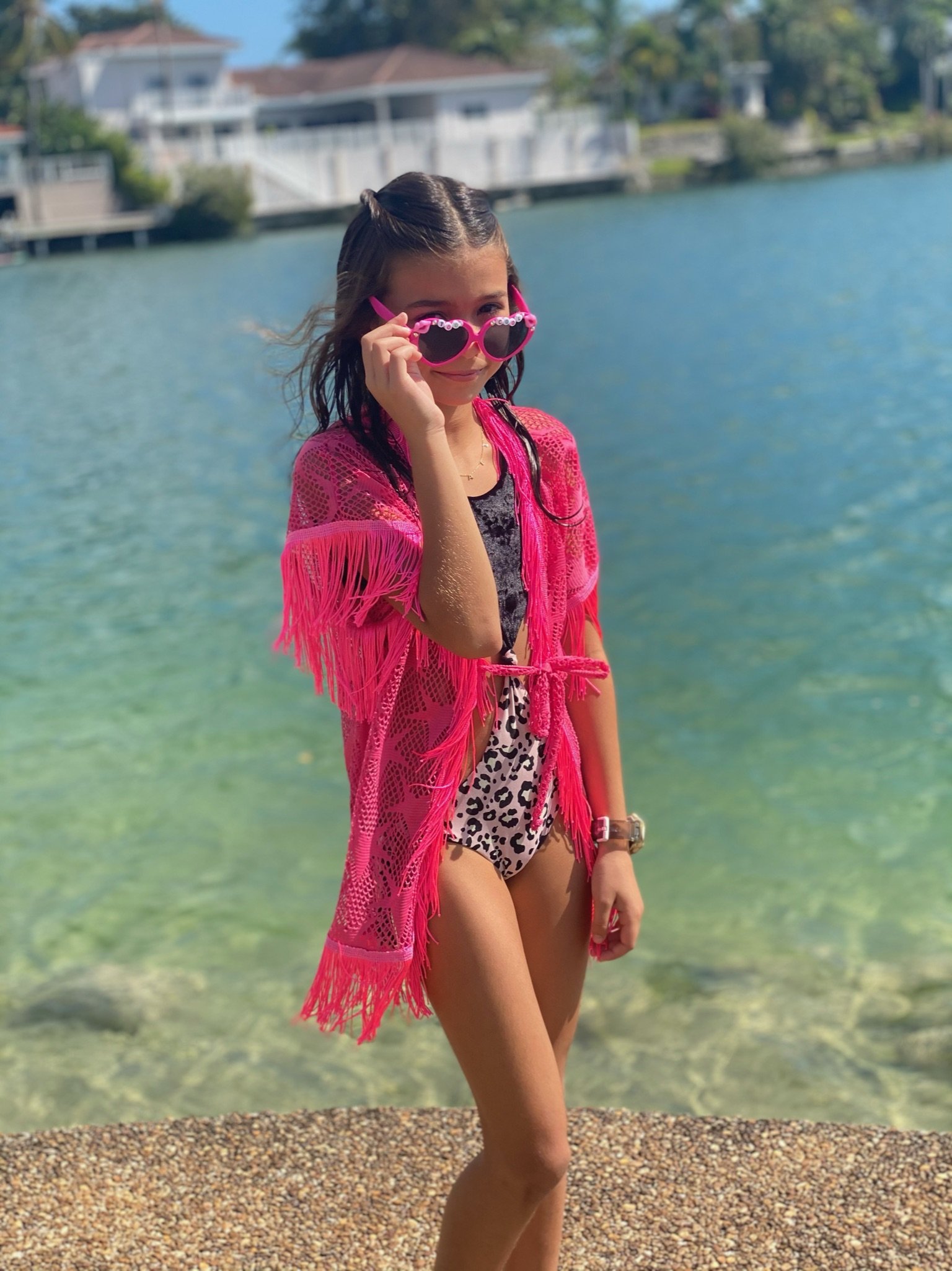 A stylish pink mesh cover up with star patterns, perfect for beach and poolside wear, showcasing its lightweight and breathable fabric.