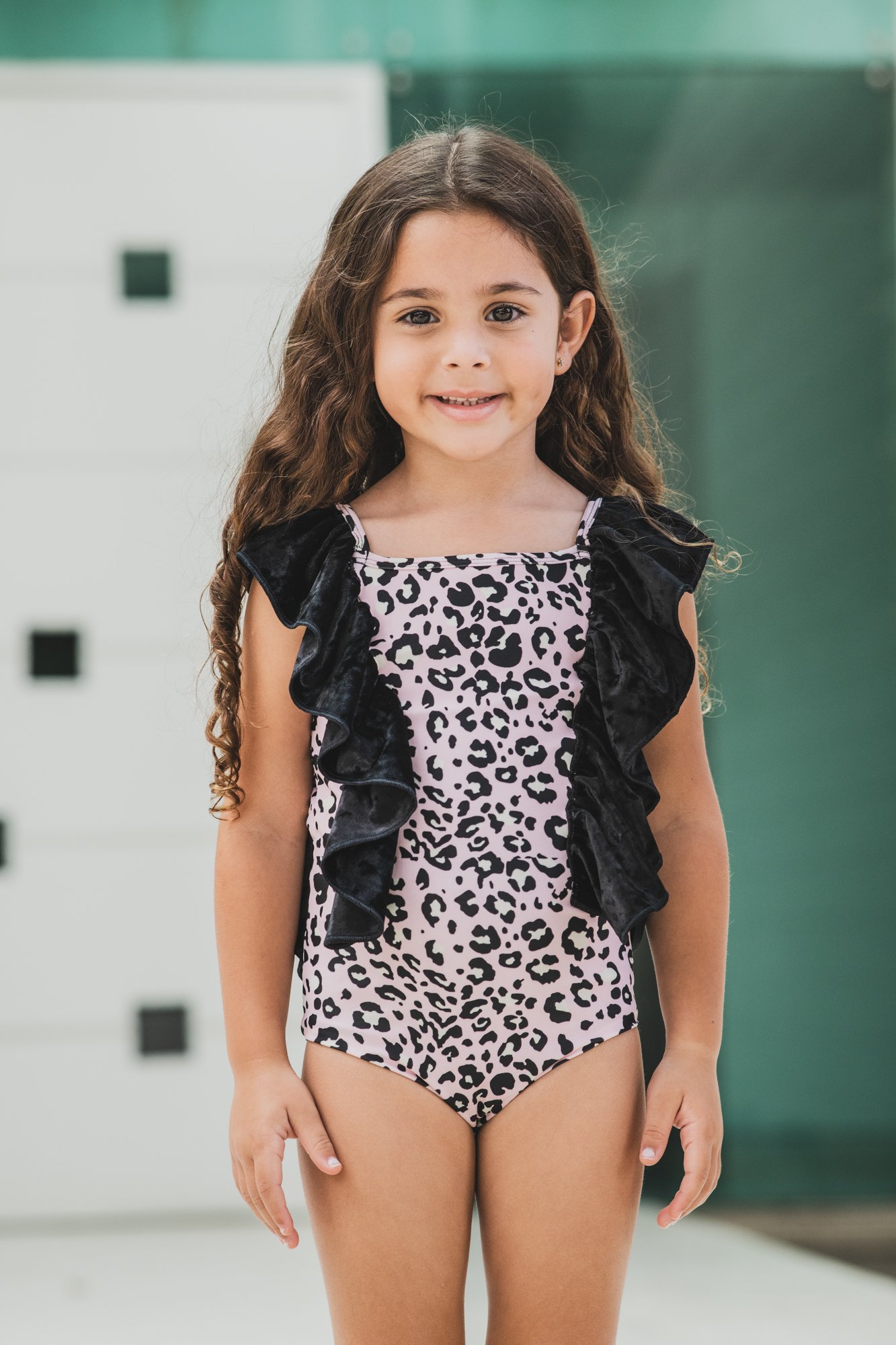 A vibrant pink leopard print one piece sleeveless kids swimwear, perfect for beach and pool activities, showcasing a stylish and comfortable design.