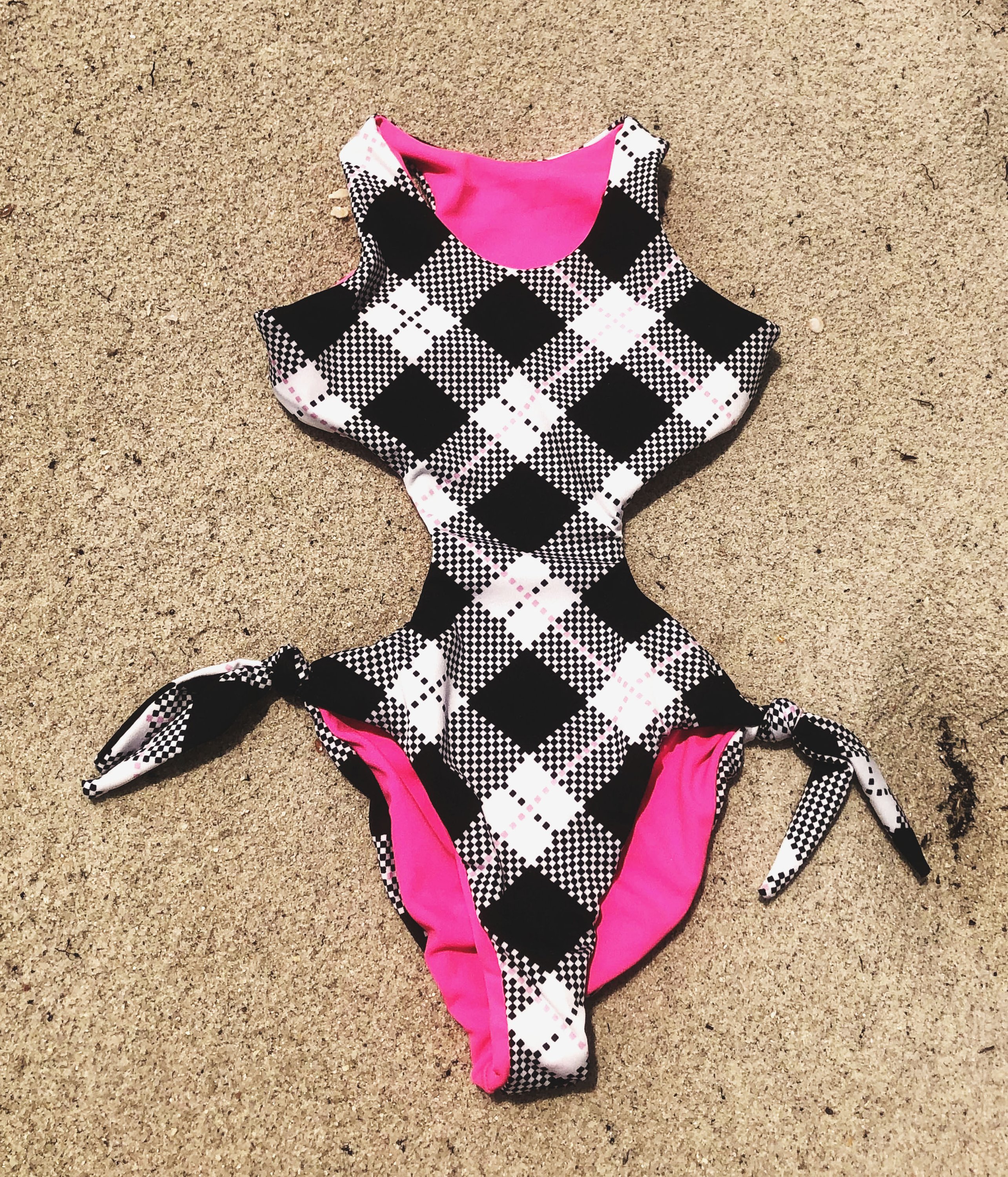 Pinky Rain Trikini for kids featuring geometric and floral patterns, adjustable ribbons, and vibrant colors, perfect for summer fun.