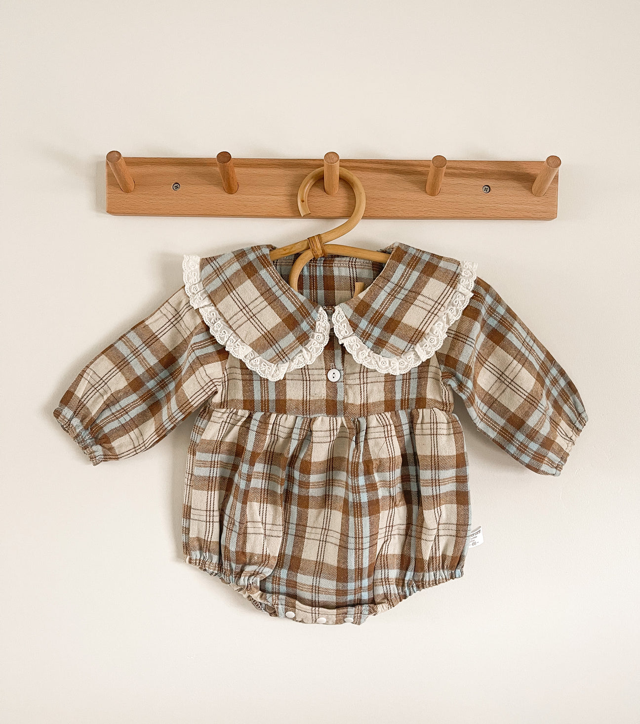 A stylish plaid vintage romper made from soft cotton, featuring a classic design suitable for casual outings.