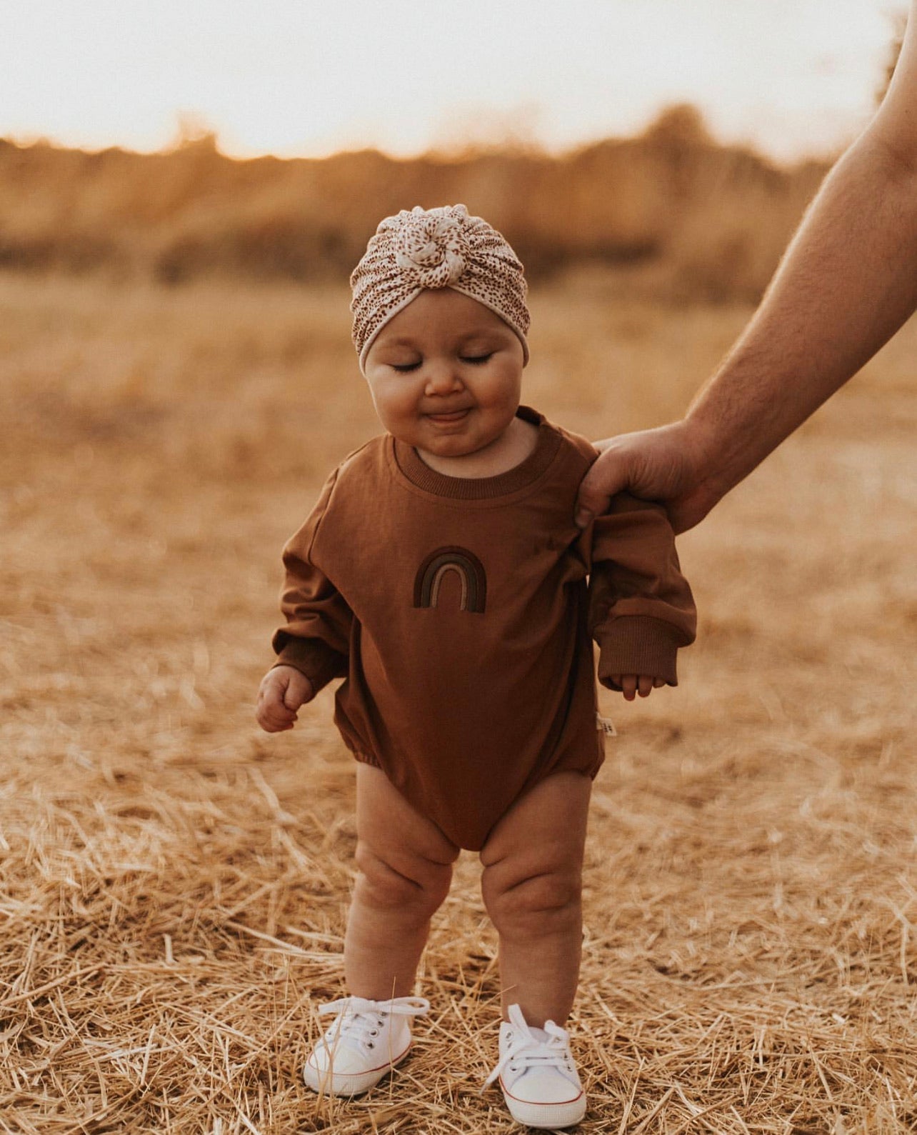 A colorful Rainbow Caramel Sweater Romper made of soft cotton, featuring vibrant hues perfect for casual or special occasions.