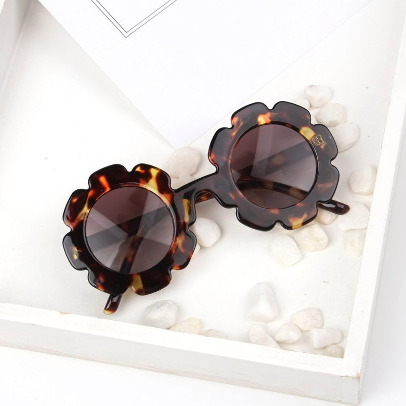 A pair of stylish seashell sunglasses with a unique design, perfect for summer beach outings.