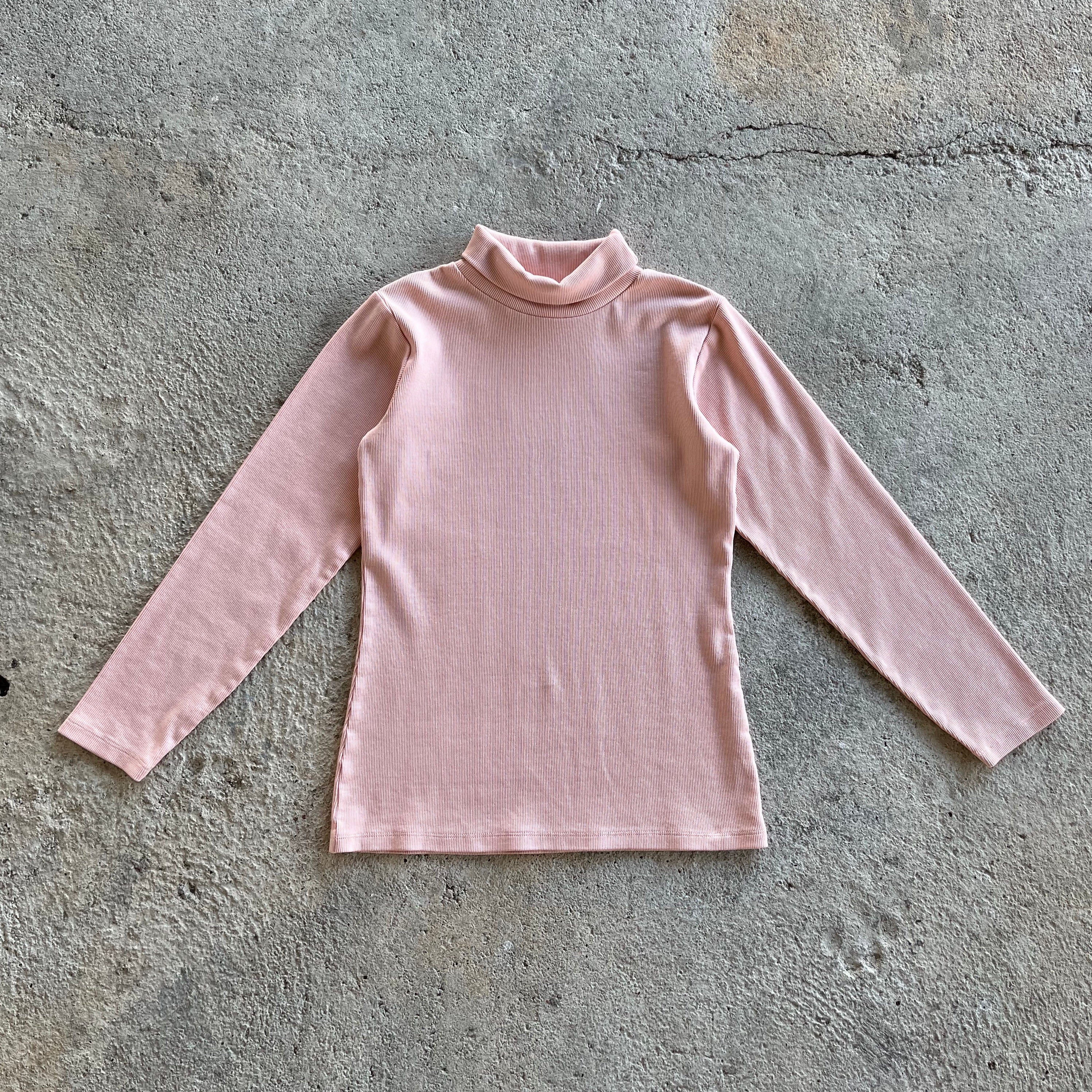 A pink ribbed long-sleeve shirt for kids with a turtle neck and round collar, made from 100% organic cotton.