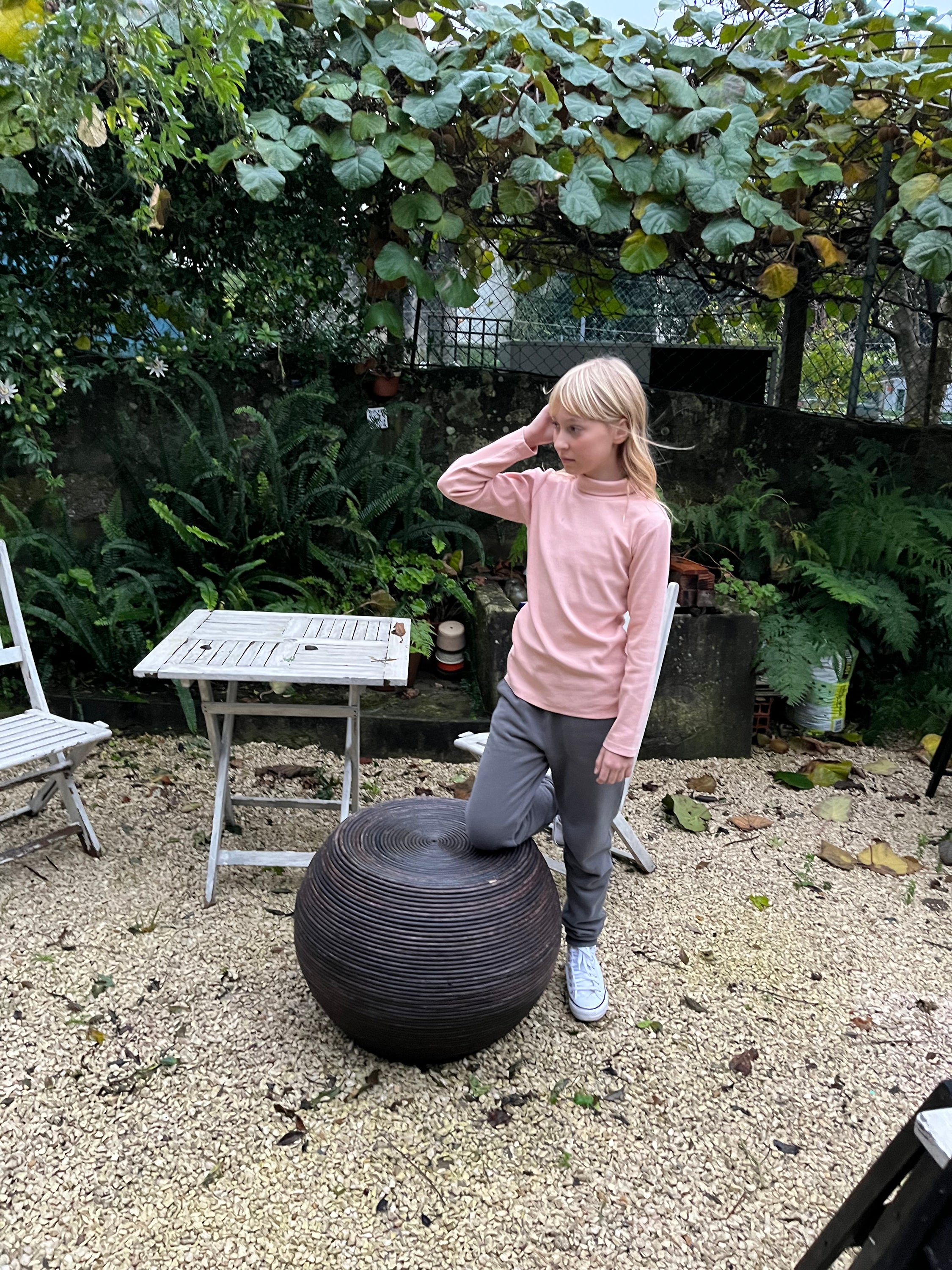 A pink ribbed long-sleeve shirt for kids with a turtle neck and round collar, made from 100% organic cotton.