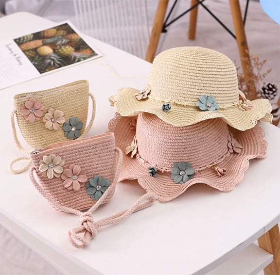 A charming straw hat adorned with multi-colored flowers and a matching straw purse with rhinestones, perfect for Spring and Summer.