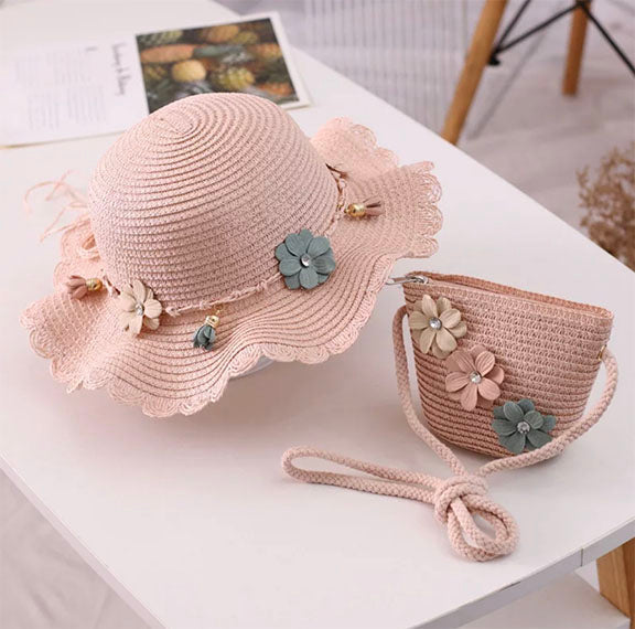 A charming straw hat adorned with multi-colored flowers and a matching straw purse with rhinestones, perfect for Spring and Summer.