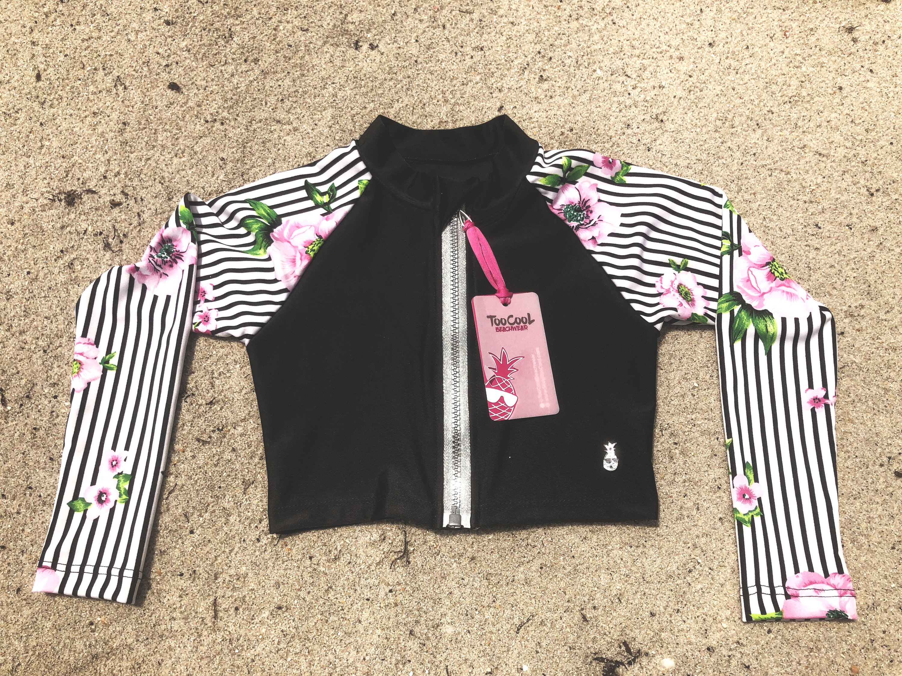 Stripetology Rash Guard Shirt for kids featuring a vibrant floral print, designed for sun protection and comfort during swim activities.