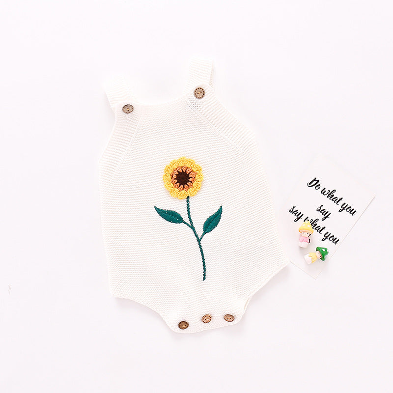 A beautiful rose and white knitted onesie featuring sunflower crochet detail and wooden button closures, perfect for babies.