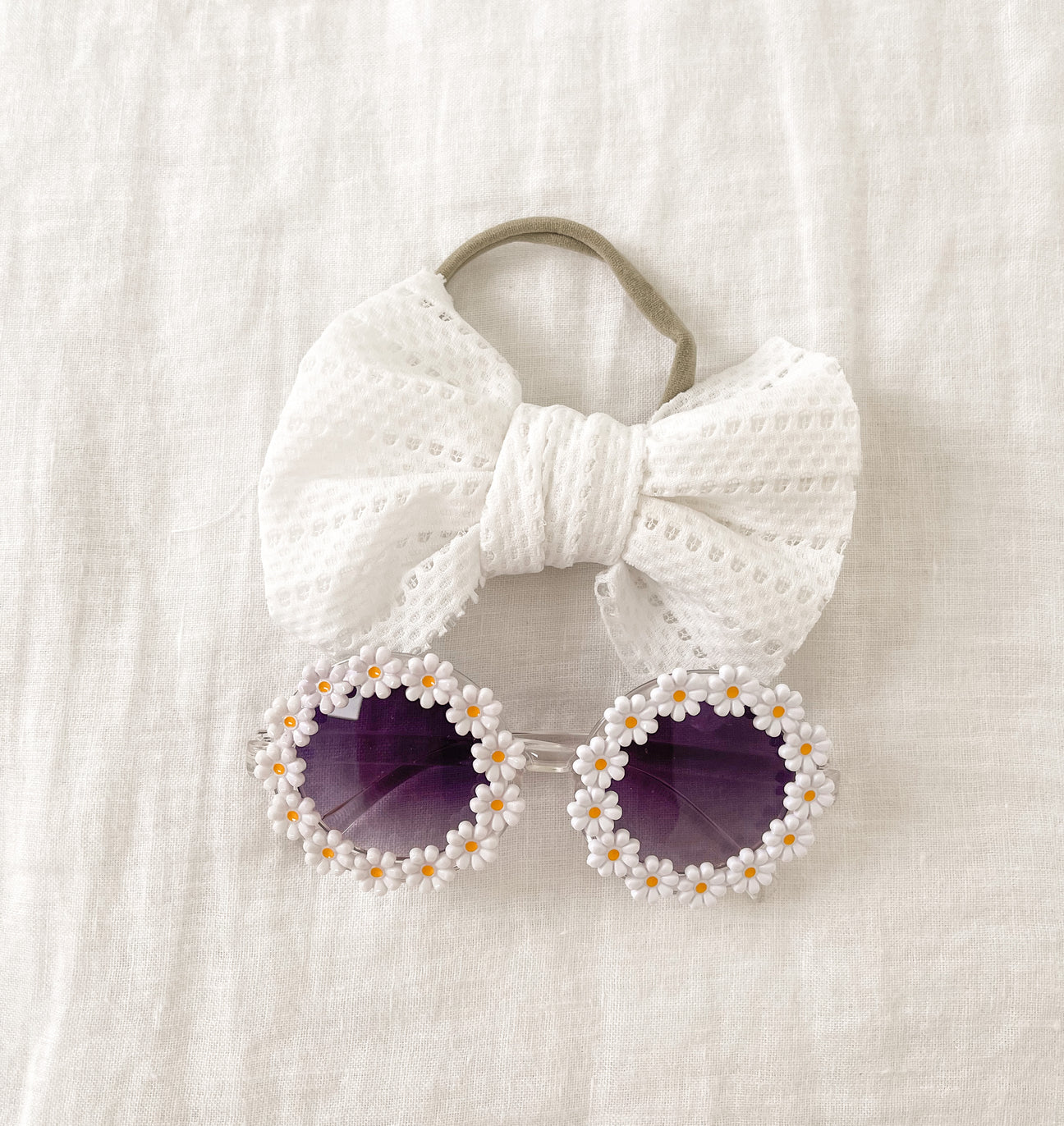 A vibrant sunflower sunglasses set with a matching bow headband, perfect for summer outings.