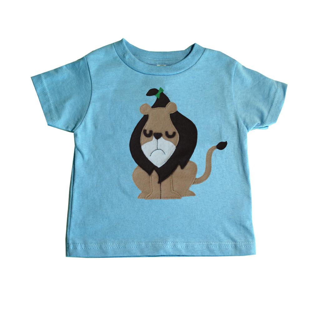 A colorful kids t-shirt featuring the Cowardly Lion from The Wonderful Wizard of Oz, handmade with eco-friendly felt appliqué.