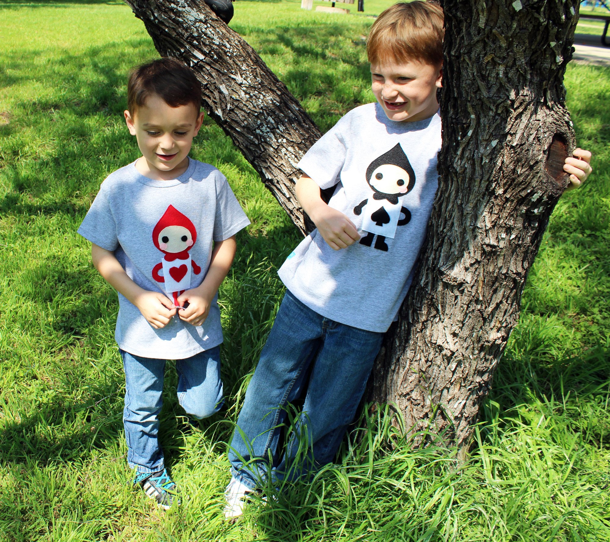 A colorful kids t-shirt featuring The Trumps Heart design inspired by Alice's Adventure in Wonderland, handmade with felt appliqué.