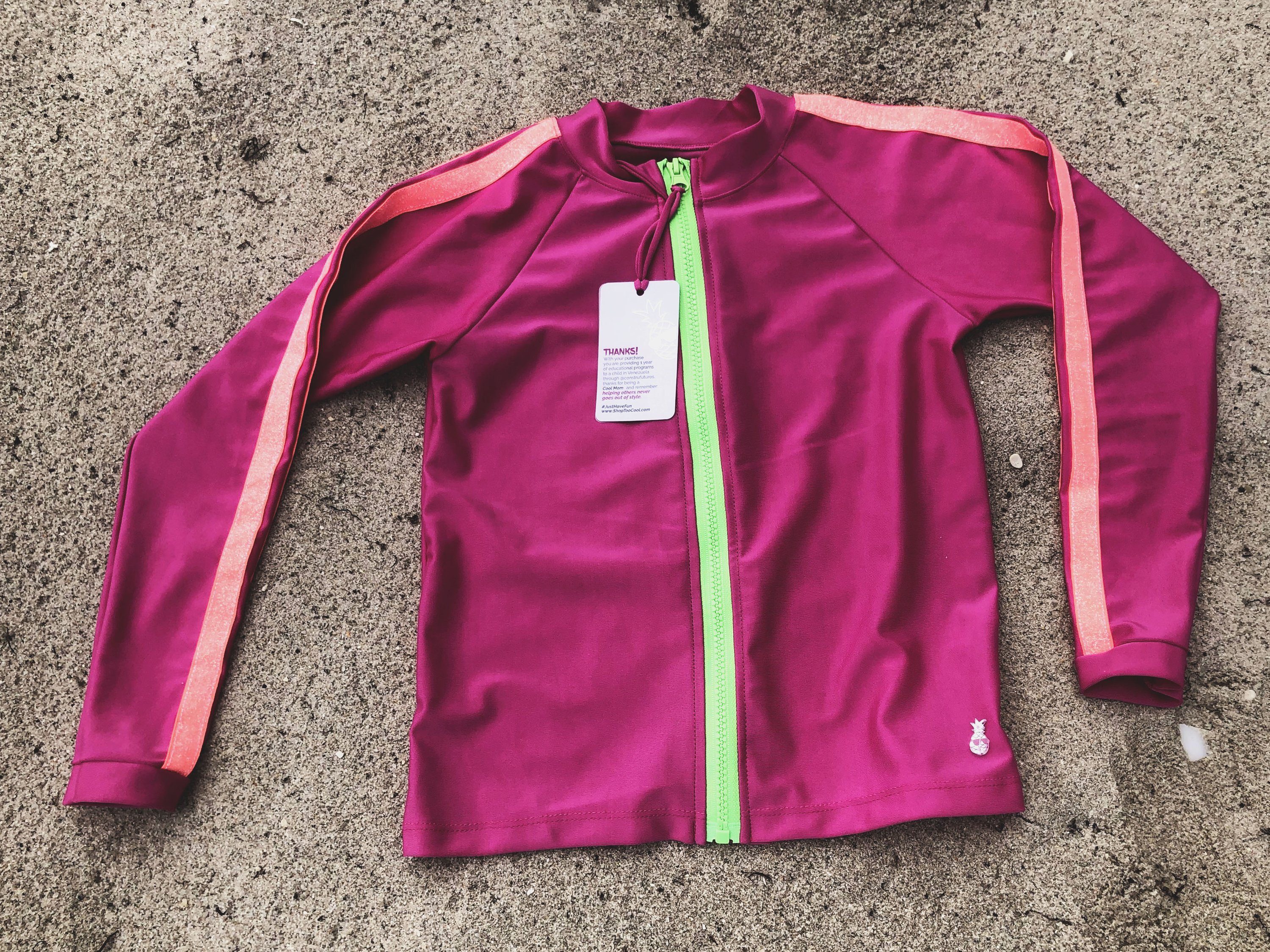 UniFucsia Rash Guard Shirt for kids, featuring vibrant colors and a stylish design, perfect for sun protection during swim activities.