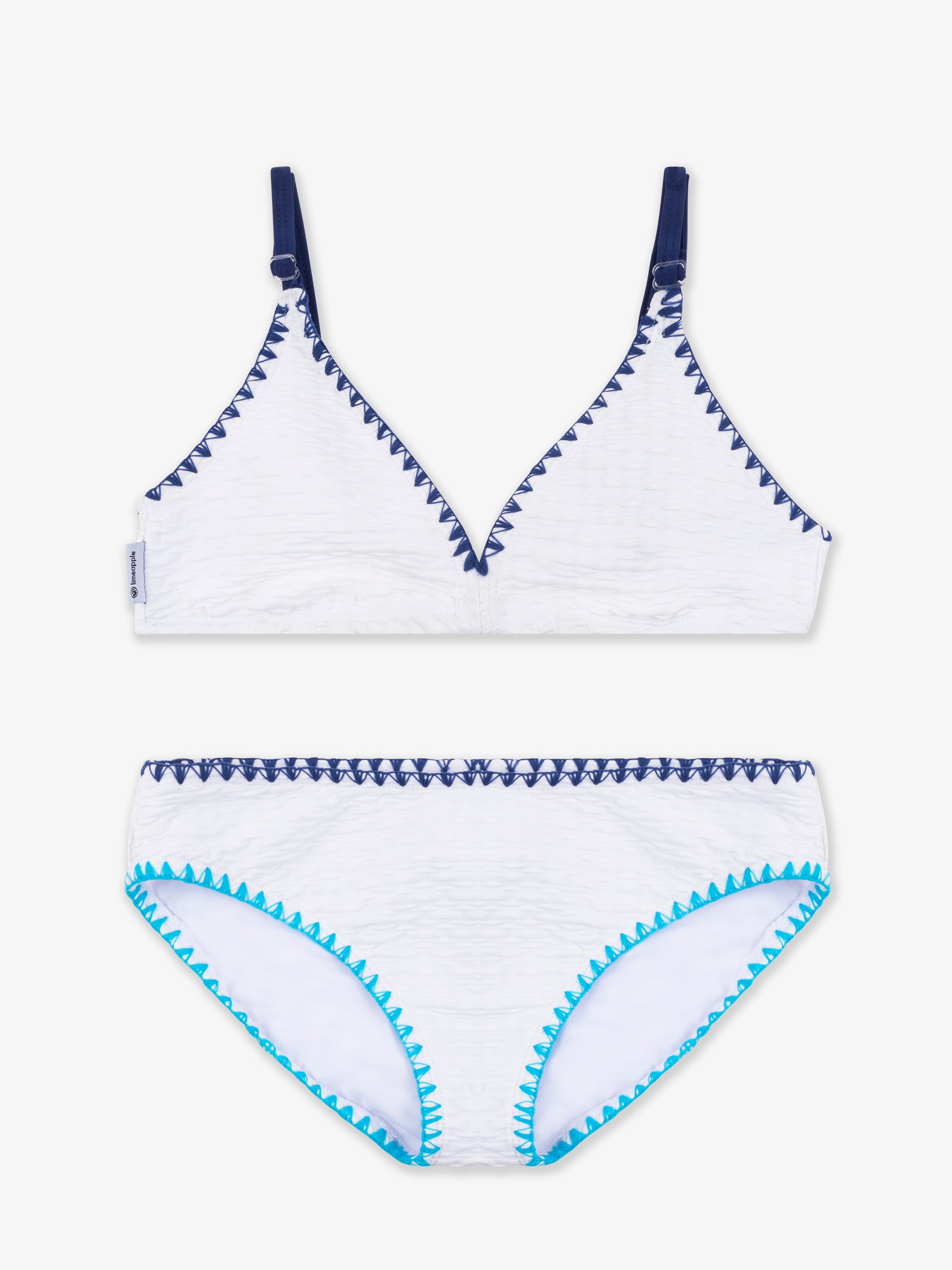 VALERIE White Trimmed Bikini featuring asymmetrical design and turquoise embroidery trim, perfect for stylish beach outings.