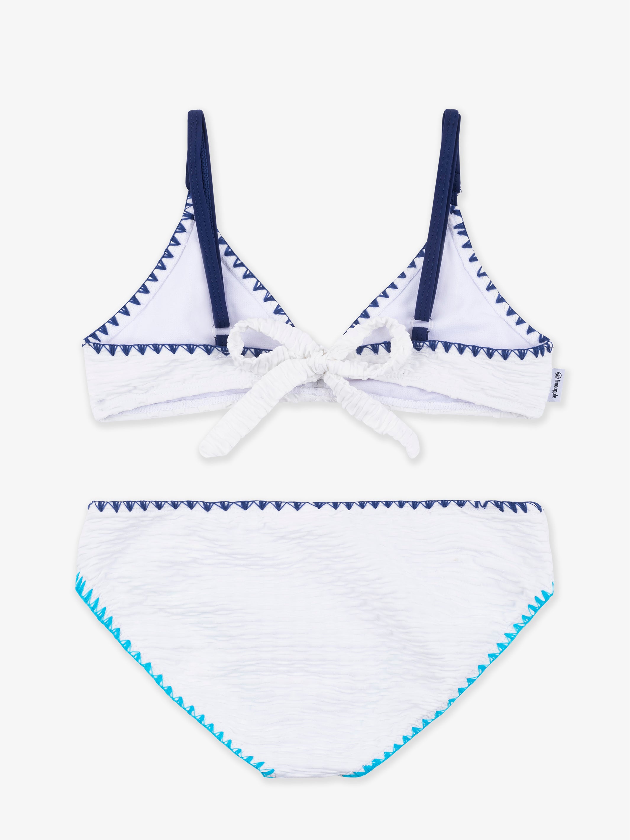 VALERIE White Trimmed Bikini featuring asymmetrical design and turquoise embroidery trim, perfect for stylish beach outings.