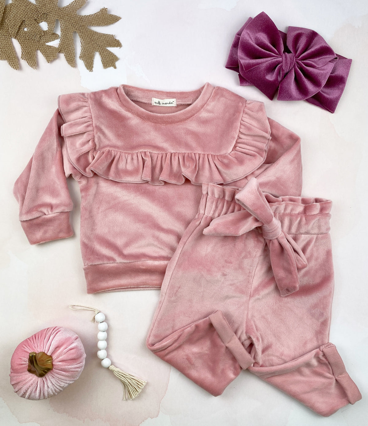 Cozy velour 2 pc set in rose color featuring ruffle details and matching pants with bow tie.