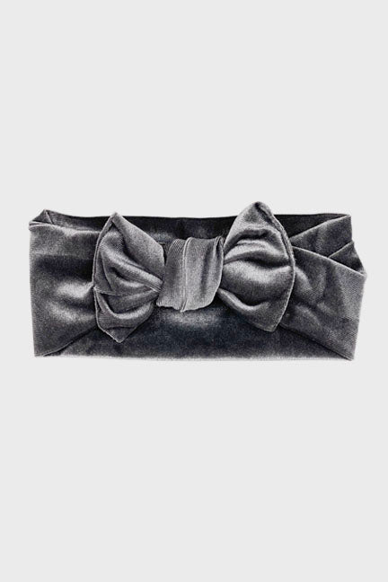 A soft velvet knot headband in a rich color, featuring a stylish bow, perfect for babies and toddlers during fall and winter.