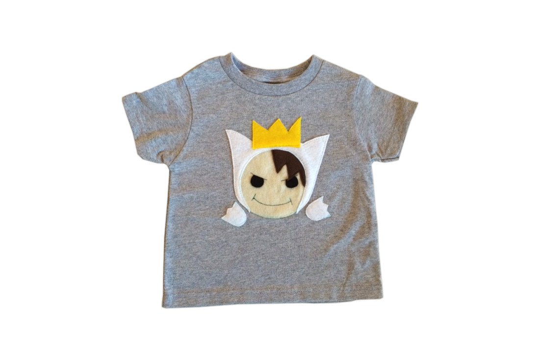 A cute Wild Boy Kids T-Shirt featuring a playful wild boy design with a crown, made from soft heather fabric, perfect for children.