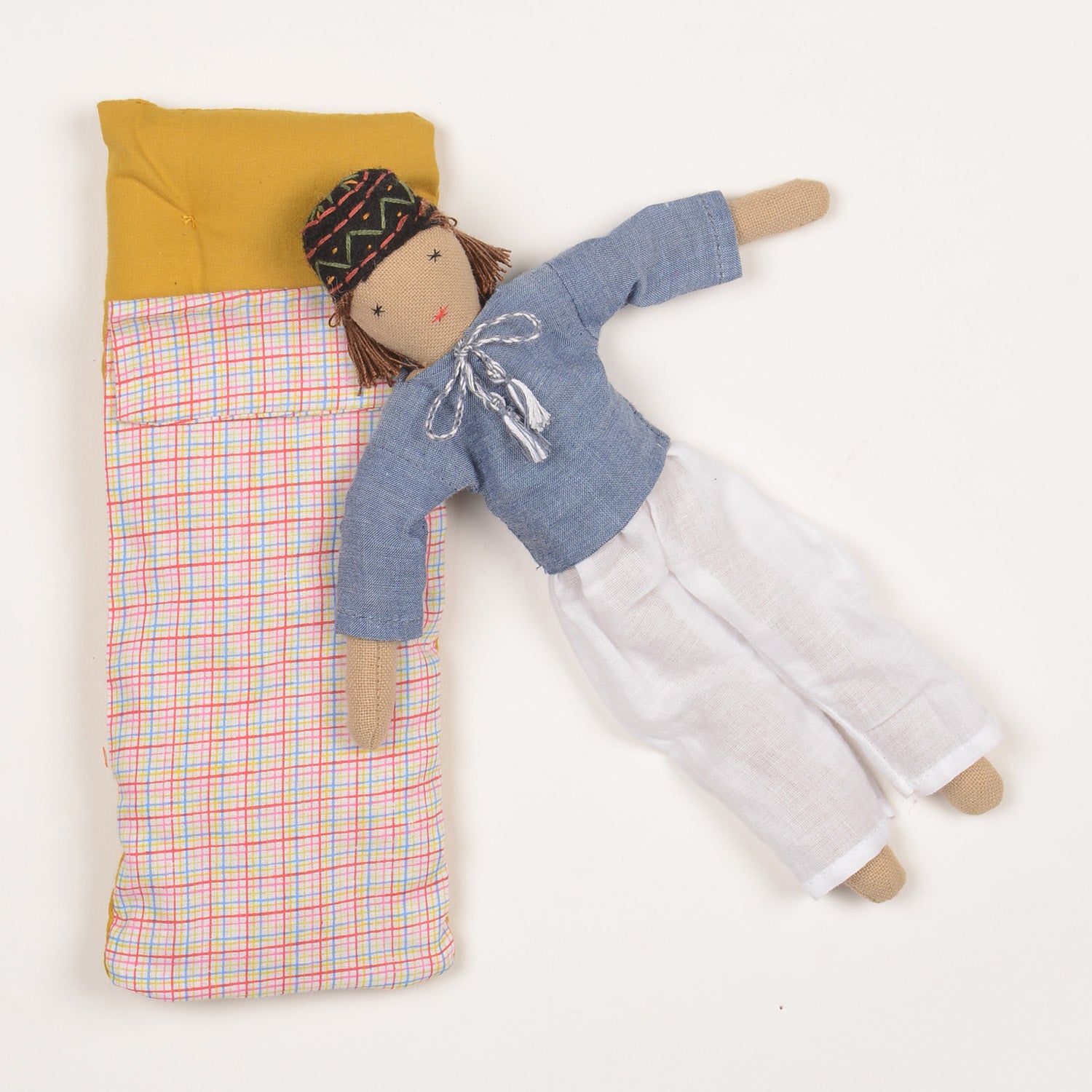 Ayu Mini Indian Baby Doll dressed in traditional kurta and pyjama, showcasing fine embroidery and woollen hair, with bedding in a foldable box.