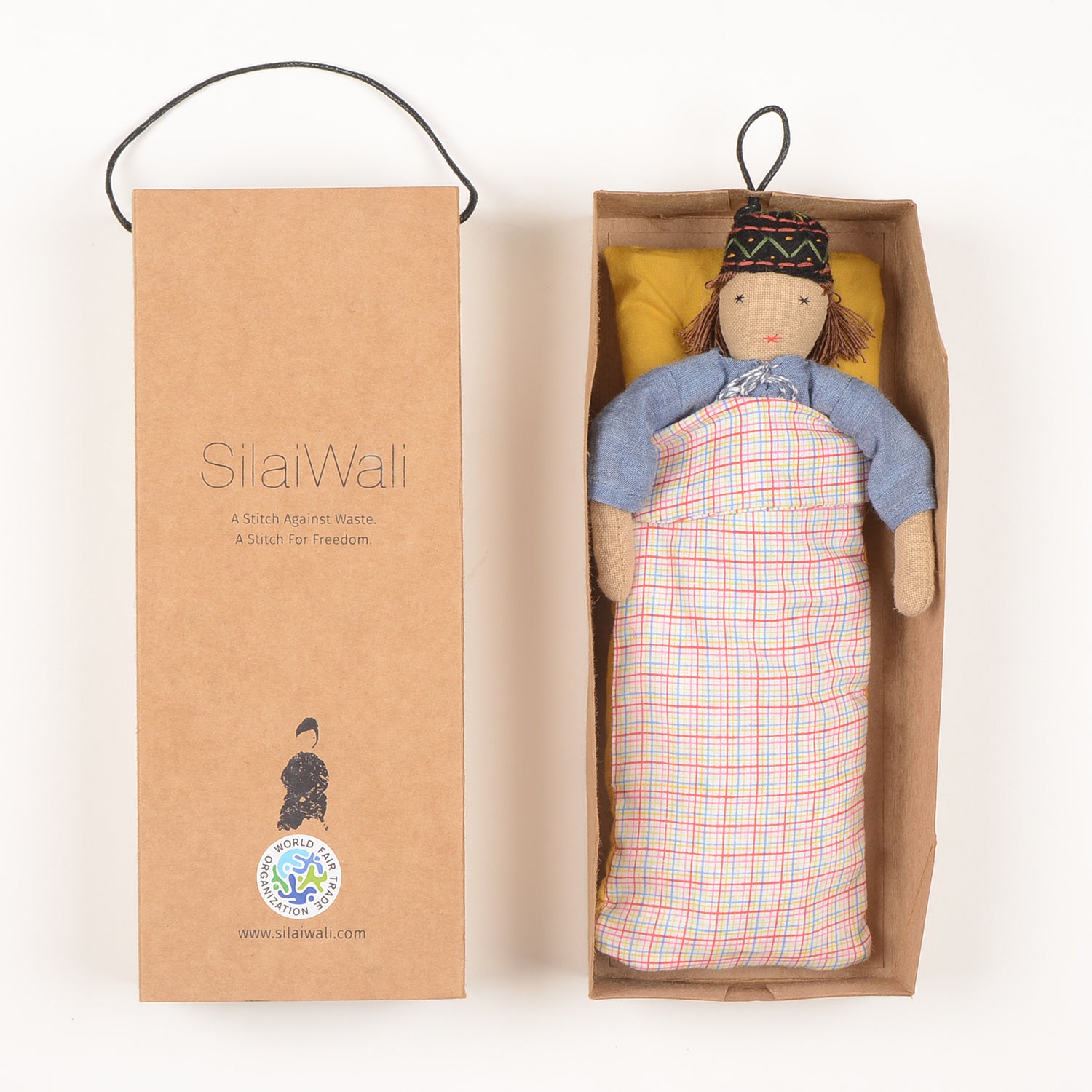 Ayu Mini Indian Baby Doll dressed in traditional kurta and pyjama, showcasing fine embroidery and woollen hair, with bedding in a foldable box.