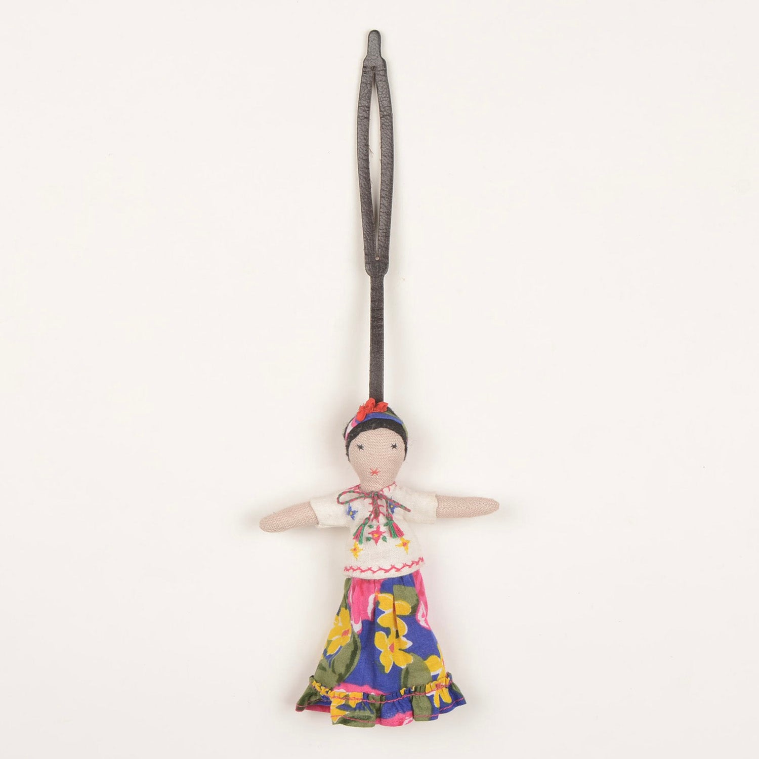 Handcrafted Bag Charm BC_FRIDA_01 made from waste fabric with a stylish leather strap, showcasing unique artisan craftsmanship.