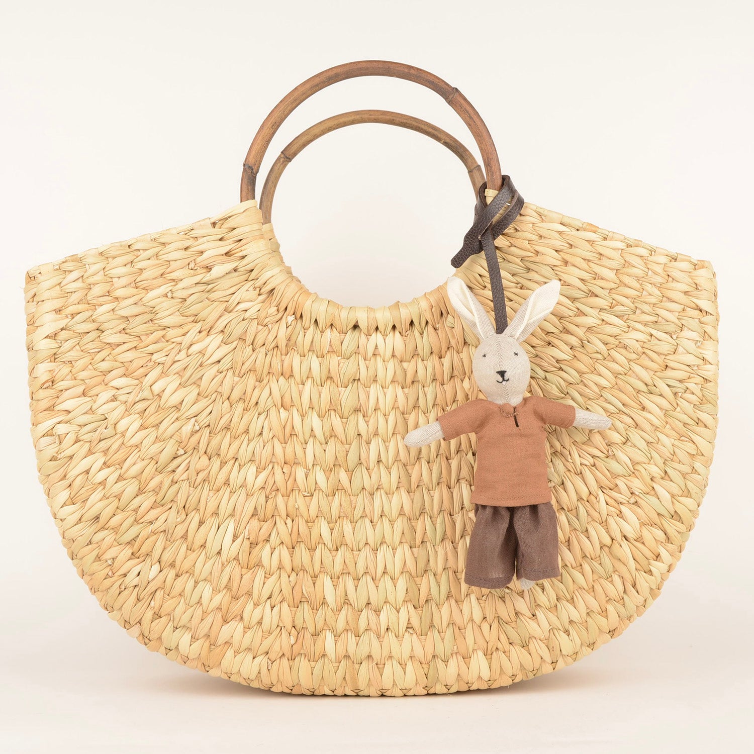 Handcrafted Bag Charm BC_UJI_01 made from waste fabric with a leather strap, showcasing unique artisan craftsmanship.