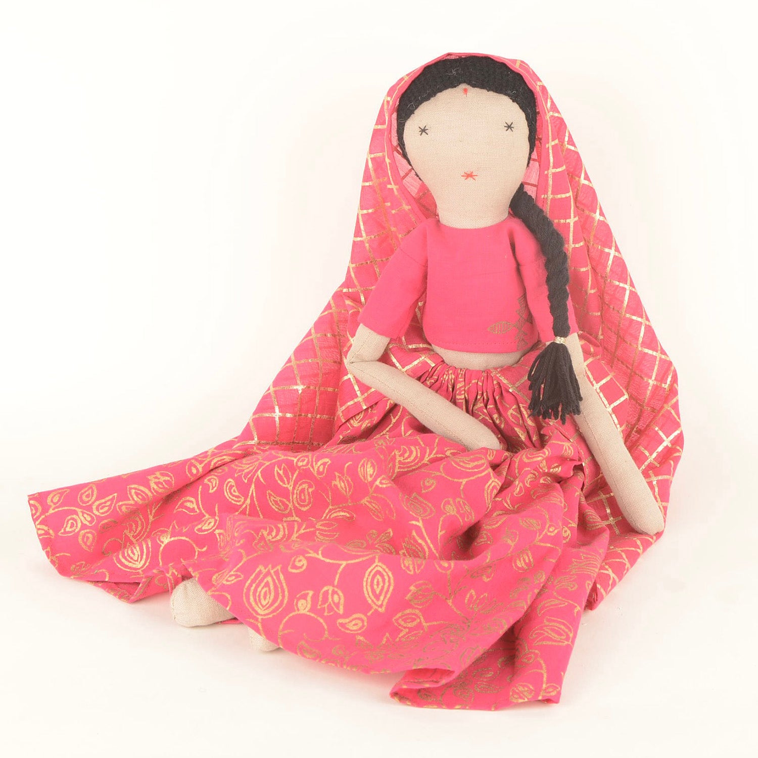 Banno doll dressed in a colorful Indian lehenga and choli, with a flowing dupatta, showcasing her playful spirit and handcrafted details.