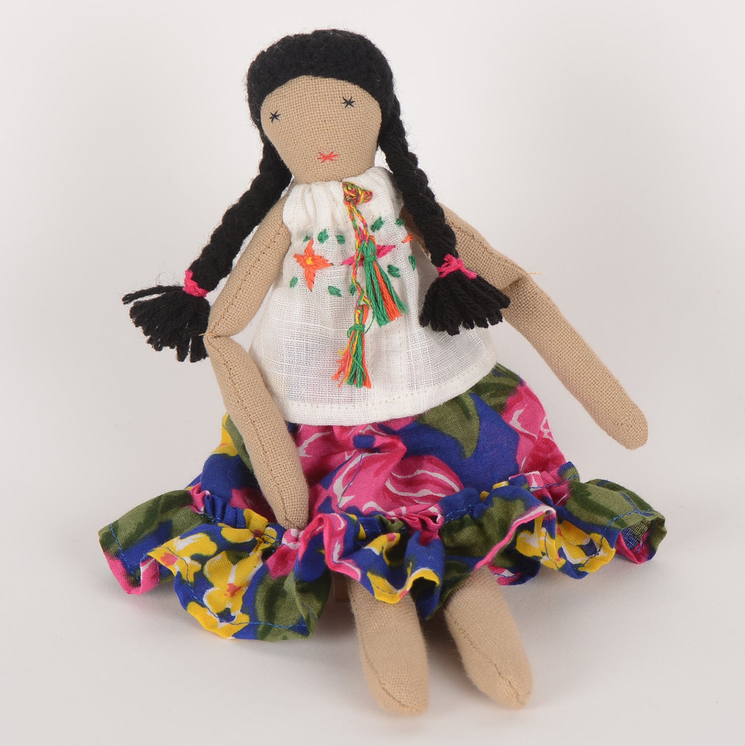 Frida Mini doll handcrafted from waste fabric, featuring bright colors and embroidered details, symbolizing love and resilience.