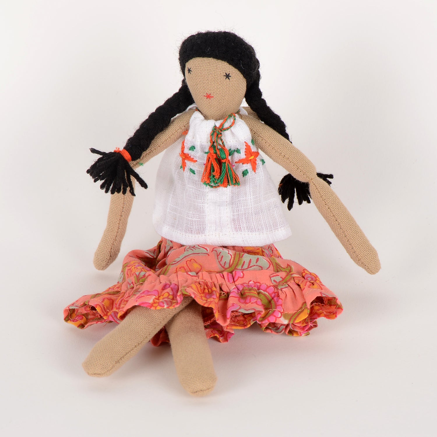 Frida Mini doll handcrafted from waste fabric, featuring bright colors and embroidered details, symbolizing love and resilience.