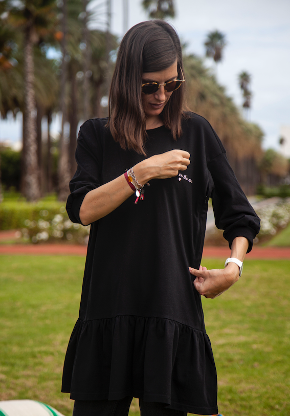 A stylish black breastfeeding dress with pink embroidery, featuring ruffles and YKK zippers for easy nursing access.