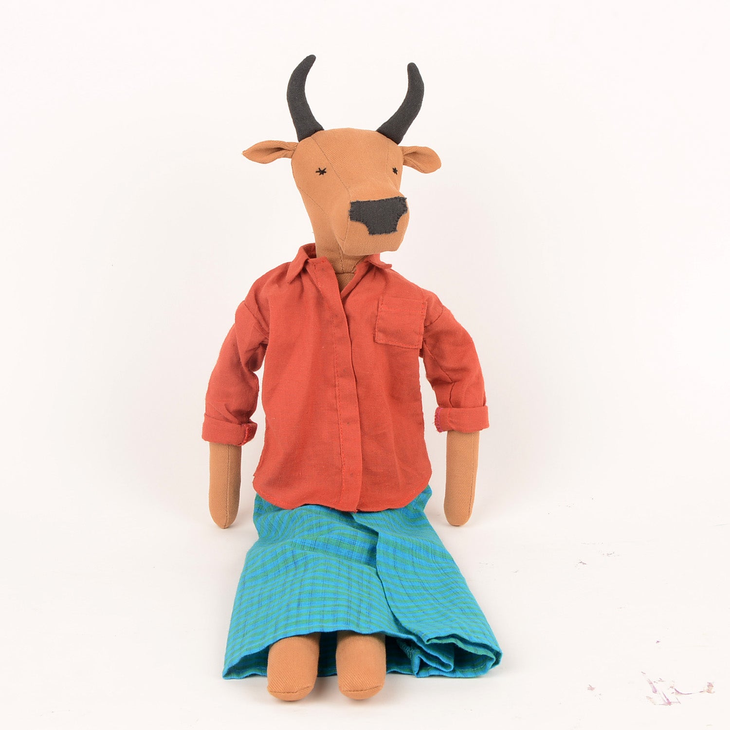 Handcrafted Nandi the Bull doll made from sustainable materials, featuring woollen hair and cotton bedding in a foldable box.