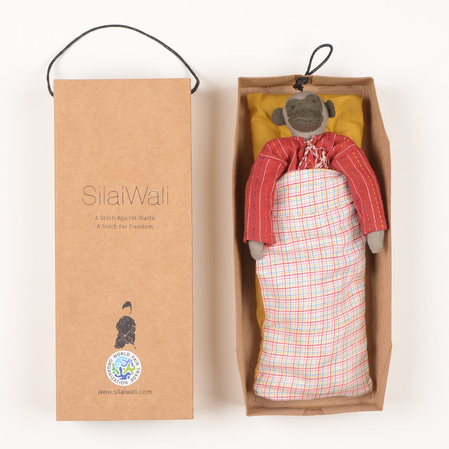 Neelu Mini, a handcrafted monkey doll made from colorful waste fabric, featuring woollen hair and cotton bedding in a foldable box.