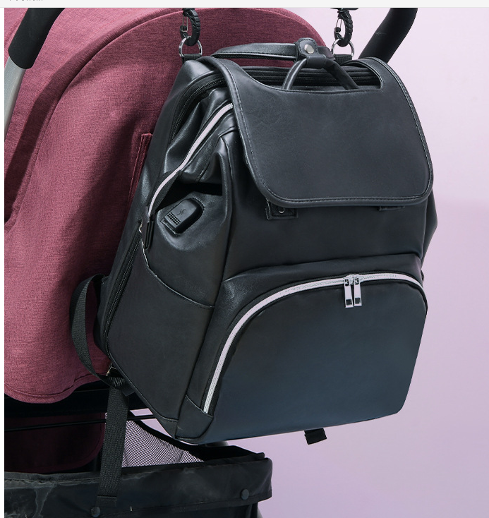 Stylish New PU Leather Diaper Bag in black, featuring multiple pockets and stroller straps, ideal for modern moms.