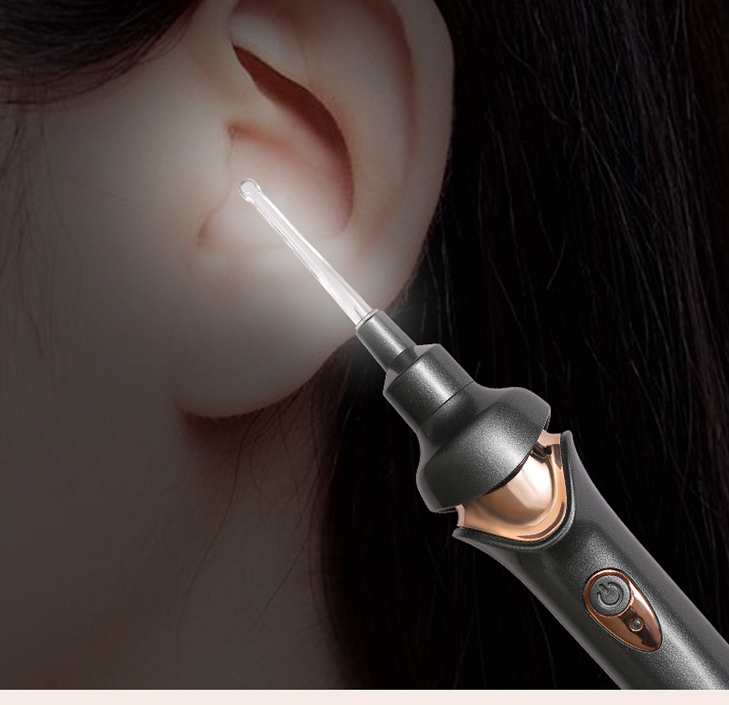 Portable rechargeable ear pick for children with luminous feature and multiple spoon heads, designed for safe ear cleaning.