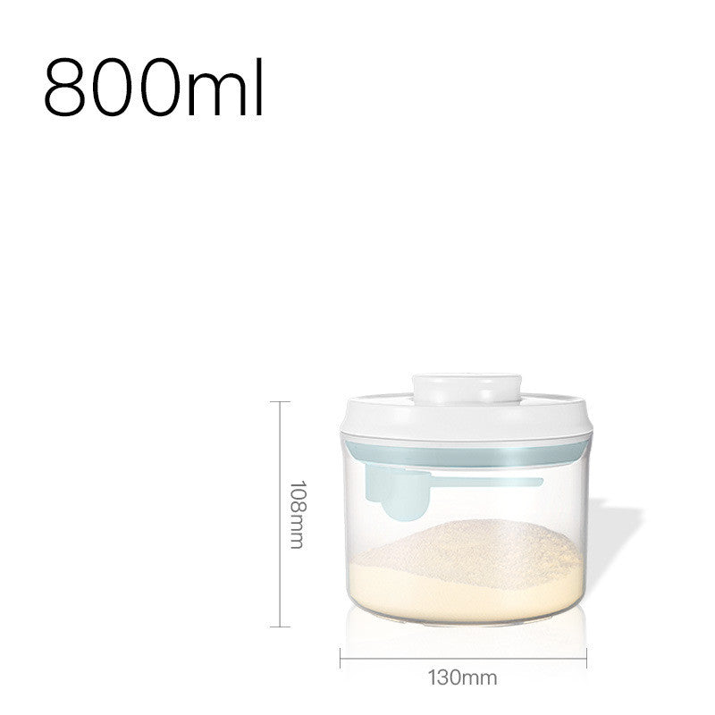 Transparent milk powder box with a one-key push-open lid, designed for moisture-proof storage and includes a hanging spoon for hygiene.