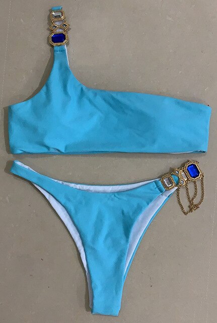 A luxurious women's bikini adorned with rhinestones and diamonds, featuring a low waist design and elegant style, perfect for beach outings.