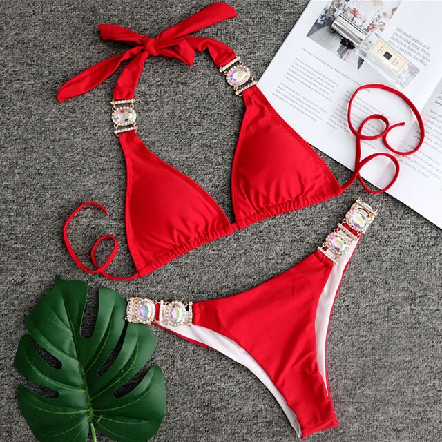 A luxurious women's bikini adorned with rhinestones and diamonds, featuring a low waist design and elegant style, perfect for beach outings.