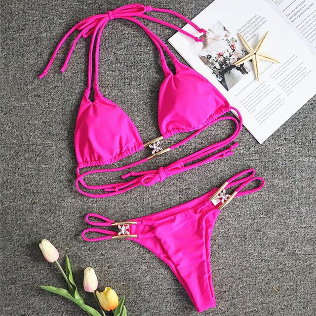 A luxurious women's bikini adorned with rhinestones and diamonds, featuring a low waist design and elegant style, perfect for beach outings.