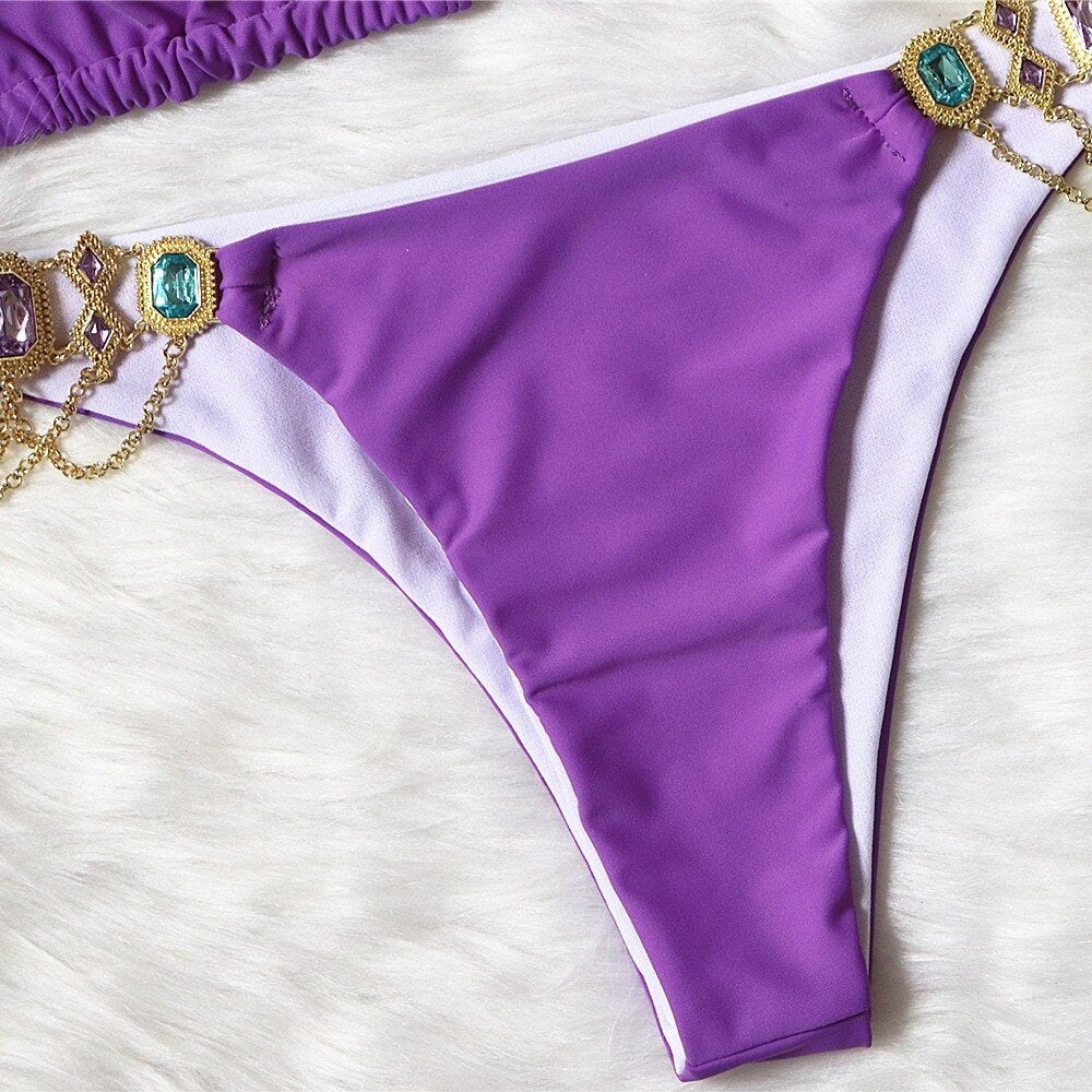 A luxurious women's bikini adorned with rhinestones and diamonds, featuring a low waist design and elegant style, perfect for beach outings.