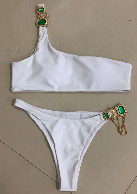 A luxurious women's bikini adorned with rhinestones and diamonds, featuring a low waist design and elegant style, perfect for beach outings.